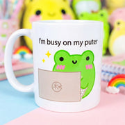 im busy on my puter frog mug by Albert the Frog on a desk beside a laptop