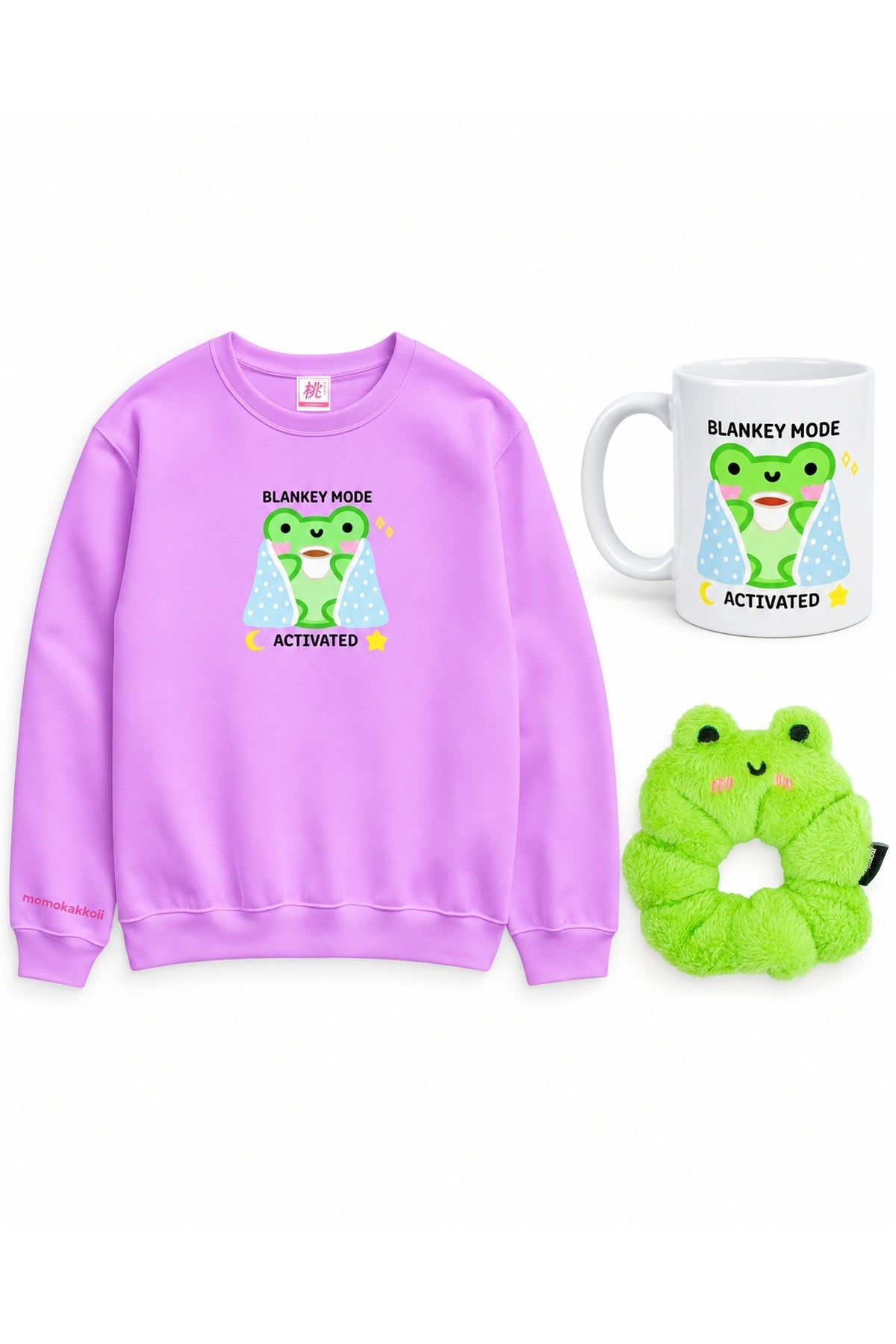 Blankey Mode bundle with purple Albert sweatshirt, ceramic mug and fluffy green frog scrunchie on white.