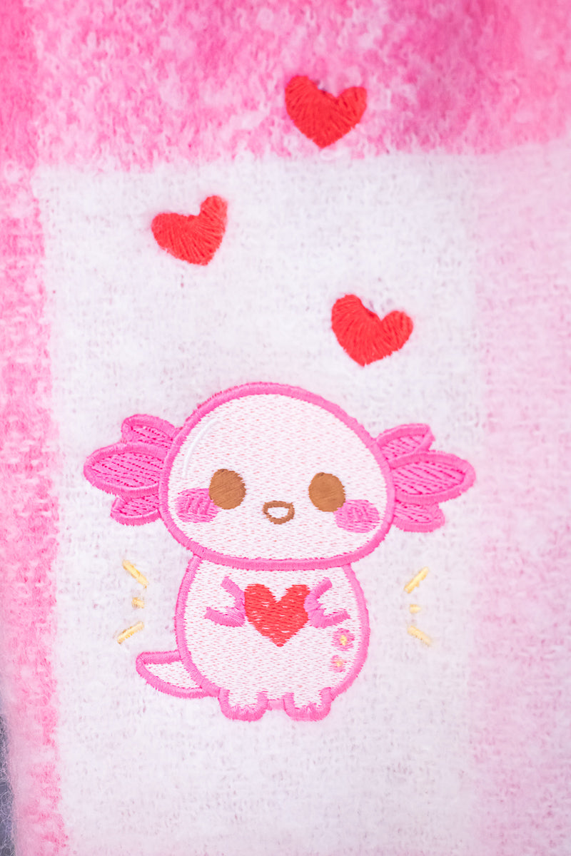 Cute xoxi the axolotl cartoon character with a heart on a pink and white background