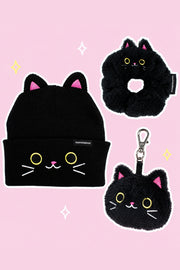Umi the Cat Winter Starter Pack: one Umi black cat-eared knit beanie, one Umi black cat ring-shaped scrunchie, one Umi plush cat-head keychain WITH its real metal clip, on a simple pastel background with white outlines and small sparkles.